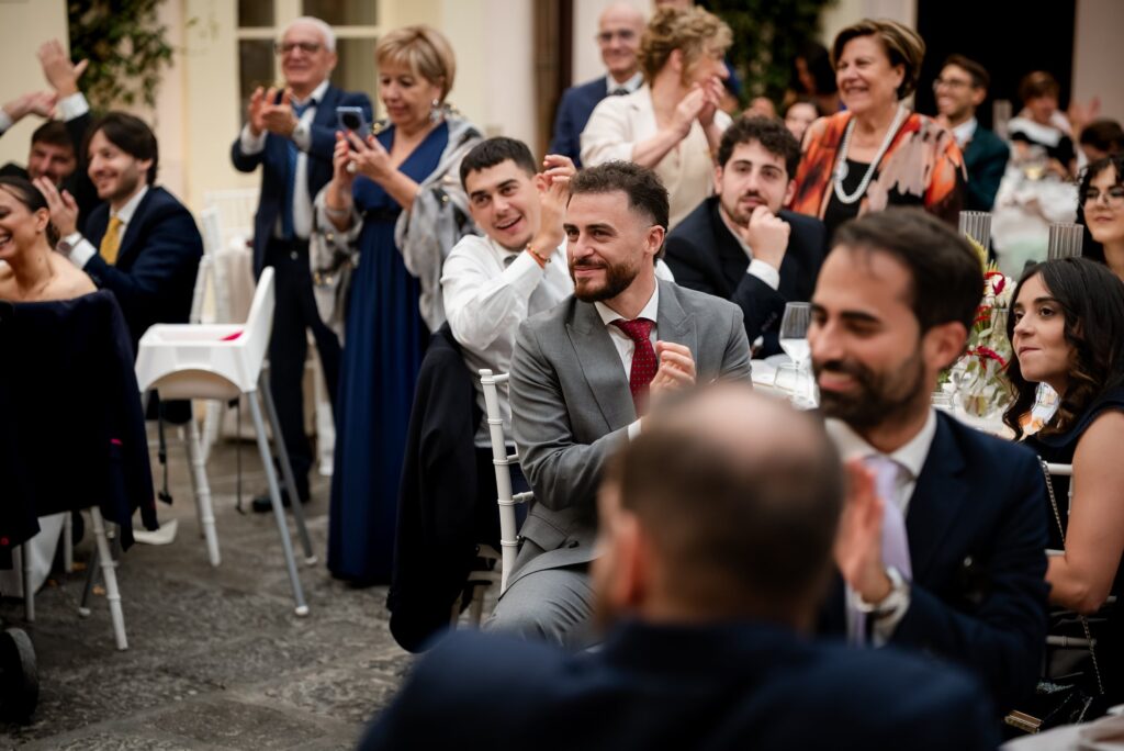 Gli invitati applaudono gli sposi nel cortile