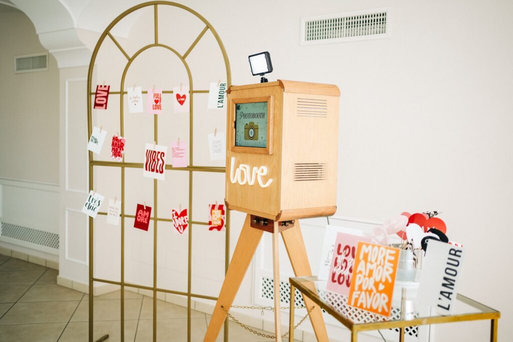 Il photobooth in sala con il fotomuro e il tavolino degli accessori