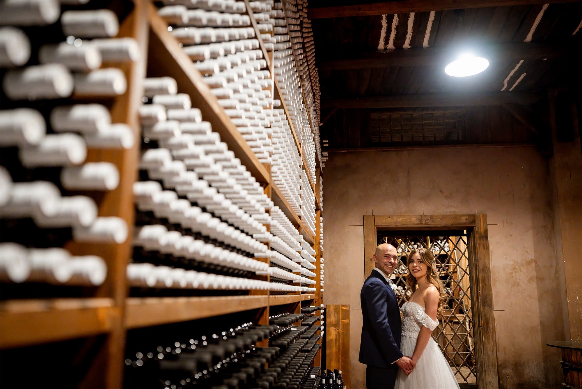 Stefano e Alessia nella cantina di Tenuta Alois, Pontelatone (Caserta) davanti alle bottiglie